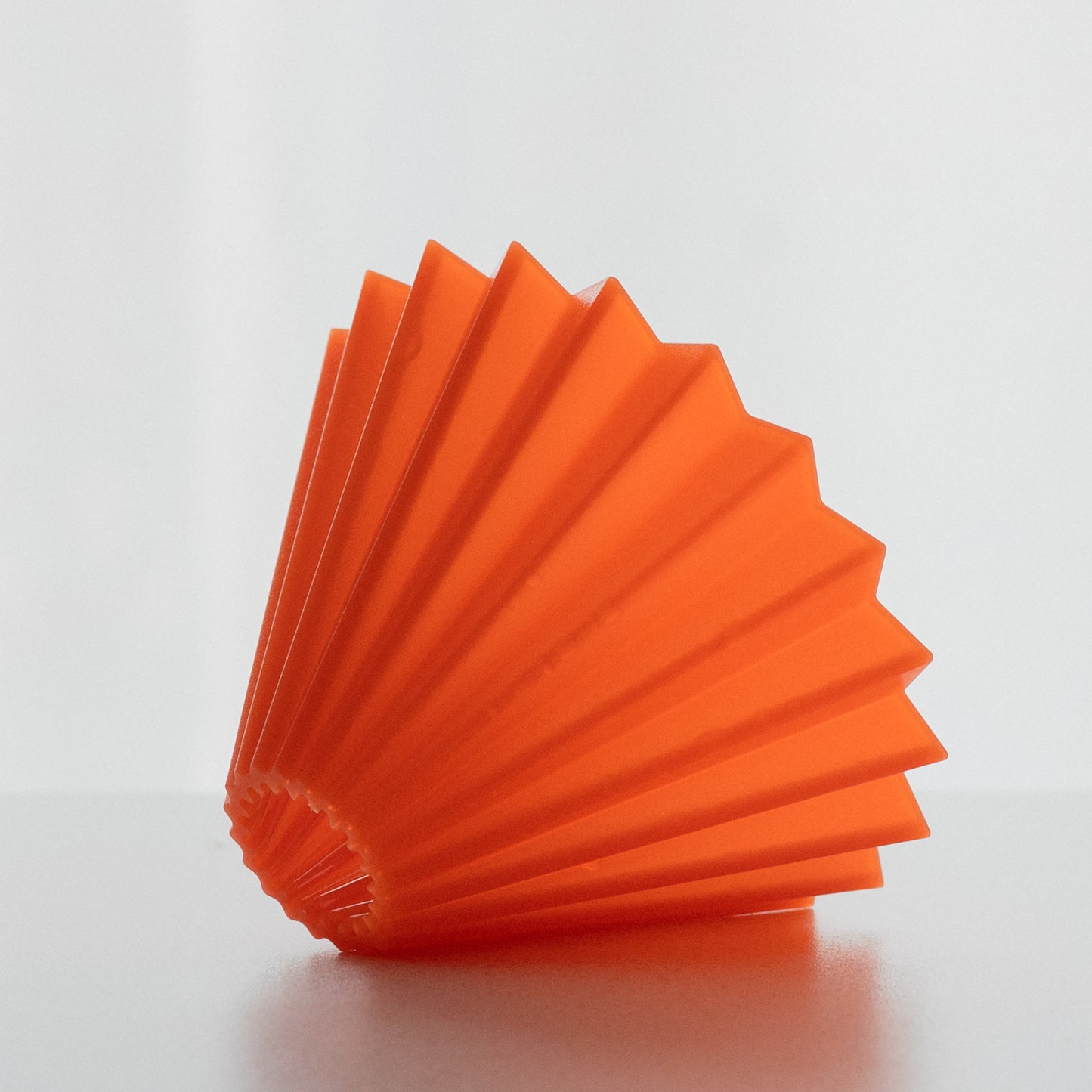 Dripper origami air orange posé sur un plan de travail de cuisine